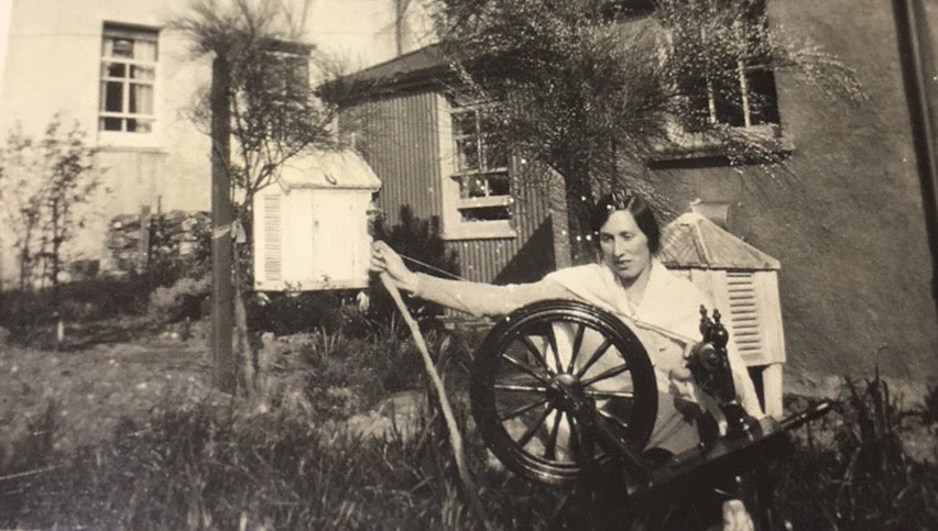 Lady spinning wool in her family back garden in Kyle of Lochalsh, Scotland